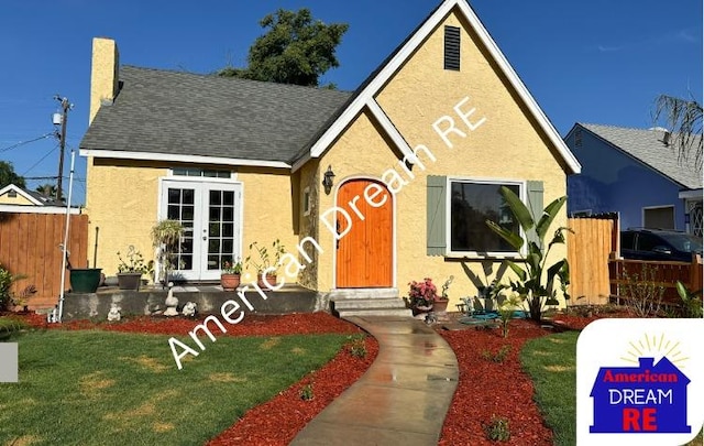 view of front of house with french doors, stucco siding, roof with shingles, and entry steps