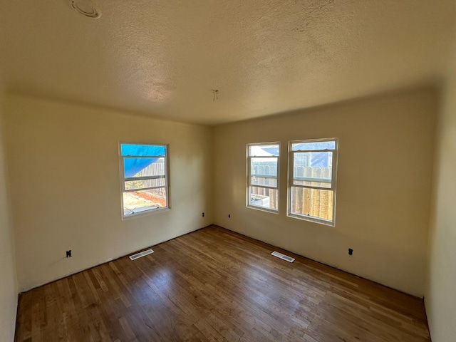 1441 N Calaveras St, Fresno, CA 93728 - unfurnished room with wood finished floors and a textured ceiling