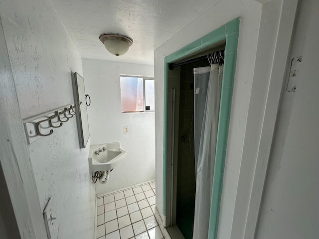 1441 N Calaveras St, Fresno, CA 93728 - full bathroom with tile patterned floors, a shower with curtain, and a textured ceiling