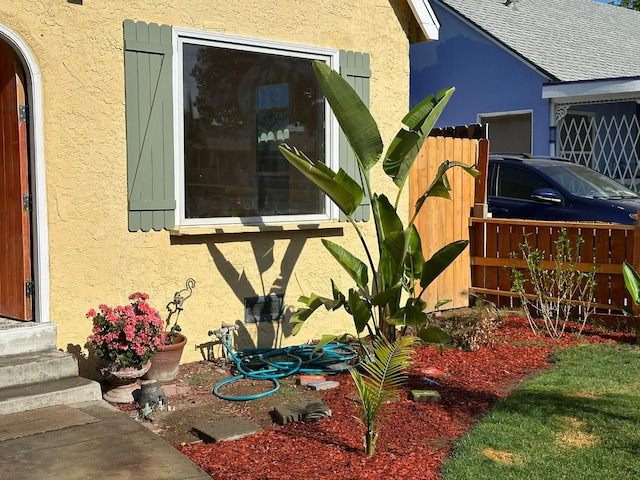 1441 N Calaveras St, Fresno, CA 93728 - view of side of home with entry steps and stucco siding