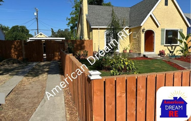 view of front of home featuring roof with shingles, stucco siding, and a chimney
