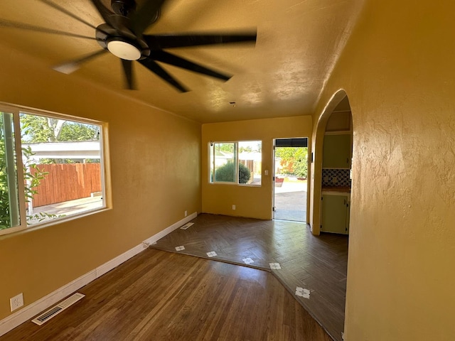 1441 N Calaveras St, Fresno, CA 93728 - spare room with ceiling fan, arched walkways, and parquet flooring