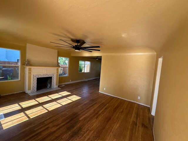 1441 N Calaveras St, Fresno, CA 93728 - unfurnished living room with wood finished floors, ceiling fan, and a tile fireplace