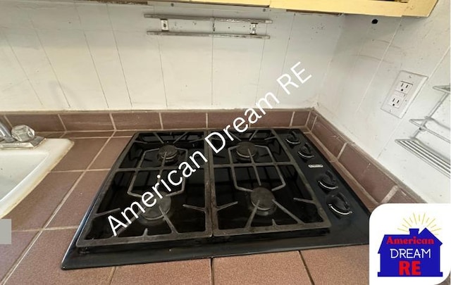 kitchen view of black gas stovetop and a sink