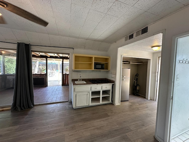 1441 N Calaveras St, Fresno, CA 93728 - kitchen featuring open shelves, freestanding refrigerator, gas cooktop, and dark wood-style flooring