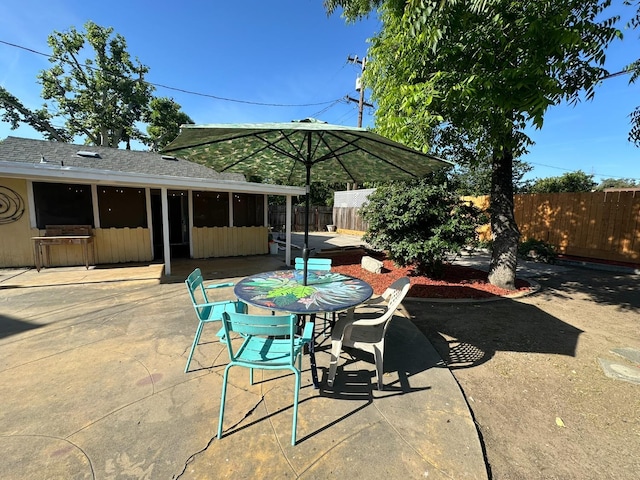 1441 N Calaveras St, Fresno, CA 93728 - view of patio / terrace featuring a sunroom and outdoor dining space