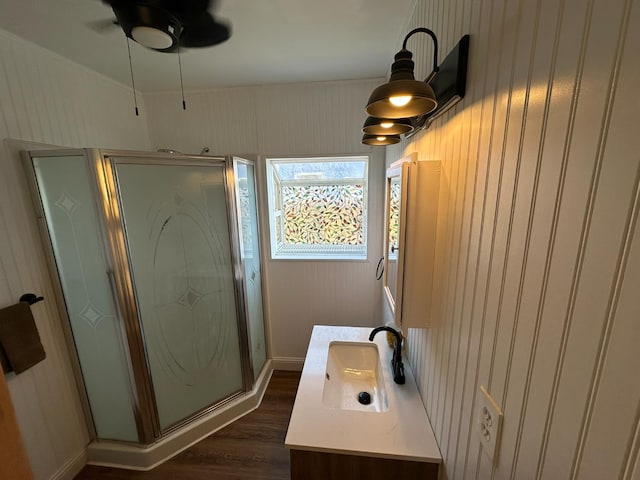1441 N Calaveras St, Fresno, CA 93728 - full bath featuring vanity, wood finished floors, a stall shower, and a ceiling fan