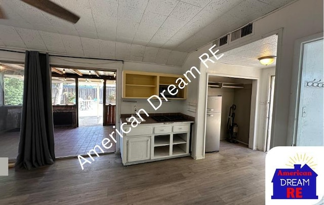 kitchen with open shelves, dark wood-style floors, water heater, and white cabinets