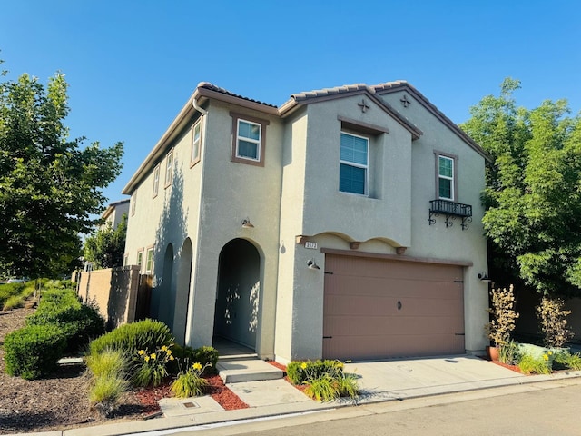 3673 Artistry Way, Clovis, CA 93619 - mediterranean / spanish-style house featuring stucco siding, a garage, concrete driveway, and a tiled roof