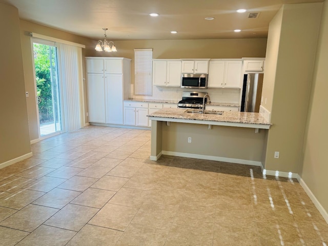 3673 Artistry Way, Clovis, CA 93619 - kitchen with appliances with stainless steel finishes, a sink, backsplash, a chandelier, and white cabinets
