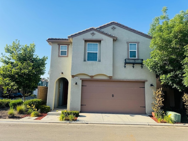 3673 Artistry Way, Clovis, CA 93619 - mediterranean / spanish-style home featuring an attached garage, stucco siding, central AC, a tile roof, and driveway