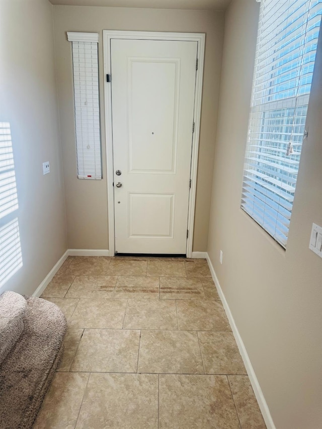 3673 Artistry Way, Clovis, CA 93619 - doorway with baseboards and light tile patterned floors