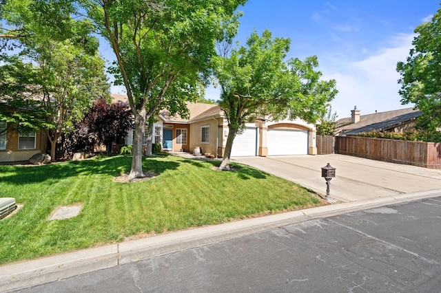 10597 E Fieldstone Ave, Clovis, CA 93619 - obstructed view of property with concrete driveway, stucco siding, and an attached garage
