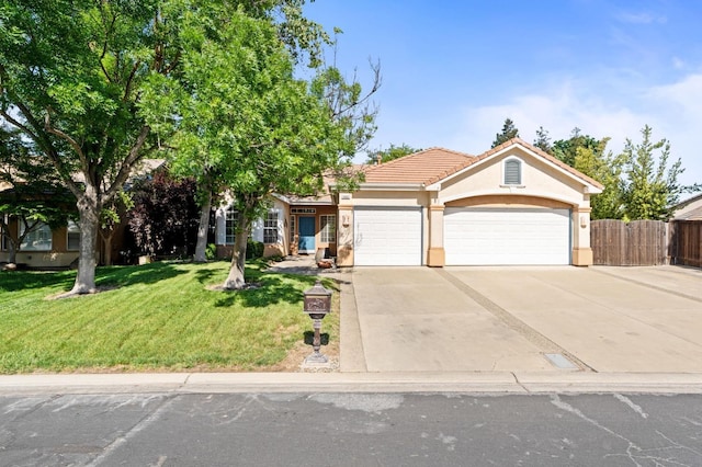 10597 E Fieldstone Ave, Clovis, CA 93619 - view of front of property featuring a garage, stucco siding, driveway, and a tile roof