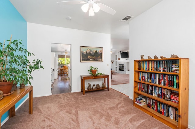 10597 E Fieldstone Ave, Clovis, CA 93619 - living area featuring a ceiling fan, carpet floors, a tile fireplace, and baseboards