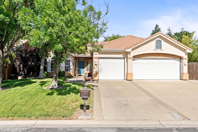 10597 E Fieldstone Ave, Clovis, CA 93619 - view of front of home featuring an attached garage, stucco siding, a front lawn, concrete driveway, and a tile roof