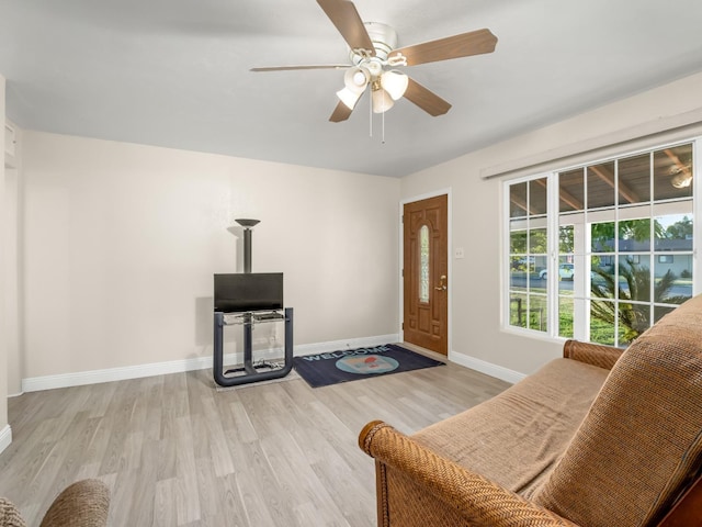 4740 E Princeton Ave, Fresno, CA 93703 - living room featuring light wood-style flooring, ceiling fan, and baseboards