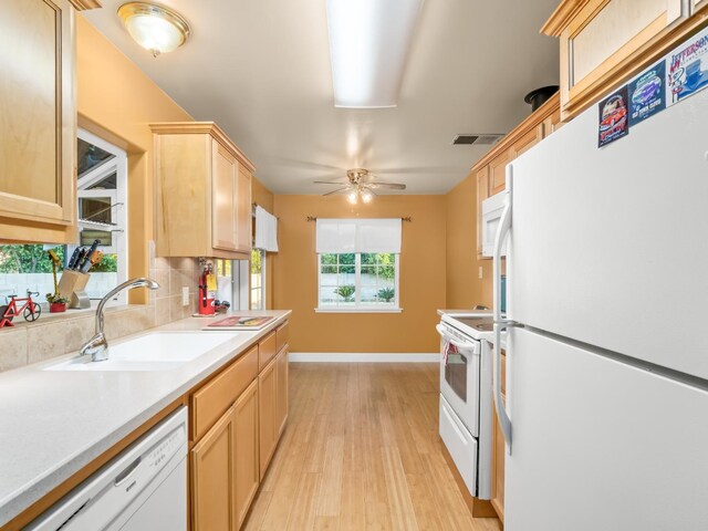 4740 E Princeton Ave, Fresno, CA 93703 - kitchen with white appliances, a sink, light brown cabinetry, light wood-style floors, and baseboards