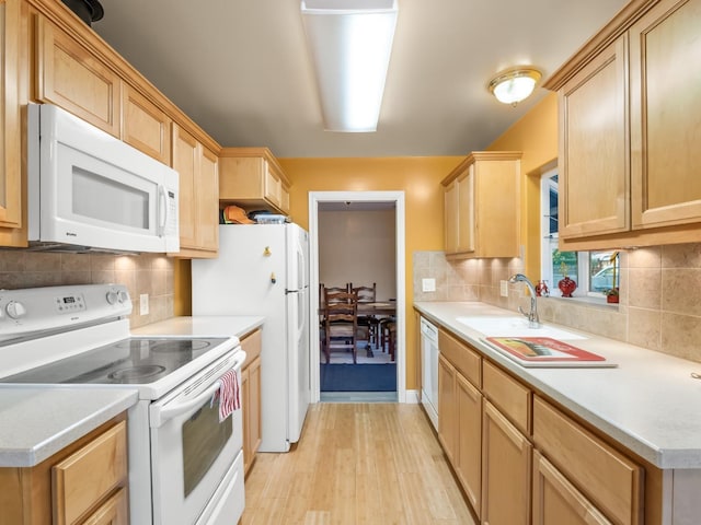 4740 E Princeton Ave, Fresno, CA 93703 - kitchen with white appliances, light wood-type flooring, light countertops, and decorative backsplash