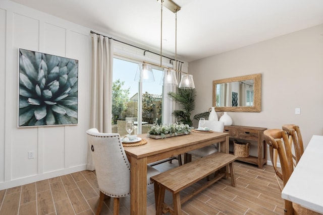 dining area featuring wood tiled floors and baseboards