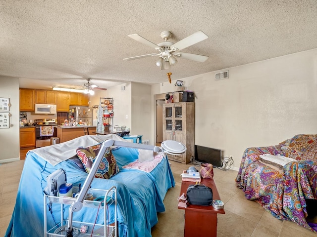 2204 Peach Ave Unit 1, Clovis, CA 93612 - bedroom featuring freestanding refrigerator, a textured ceiling, light tile patterned floors, and a ceiling fan