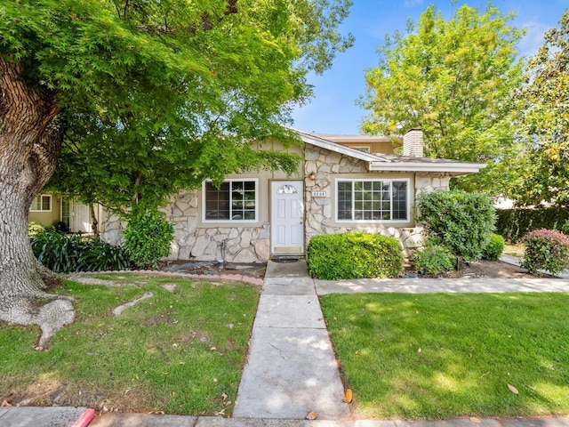 2204 Peach Ave Unit 1, Clovis, CA 93612 - view of front of house with stone siding, a chimney, and a front yard