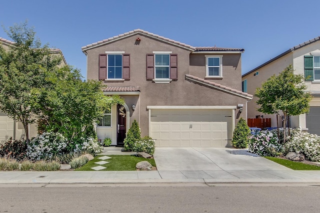 3877 Griffith Ave, Clovis, CA 93619 - view of front of house featuring a tile roof, concrete driveway, a garage, and stucco siding