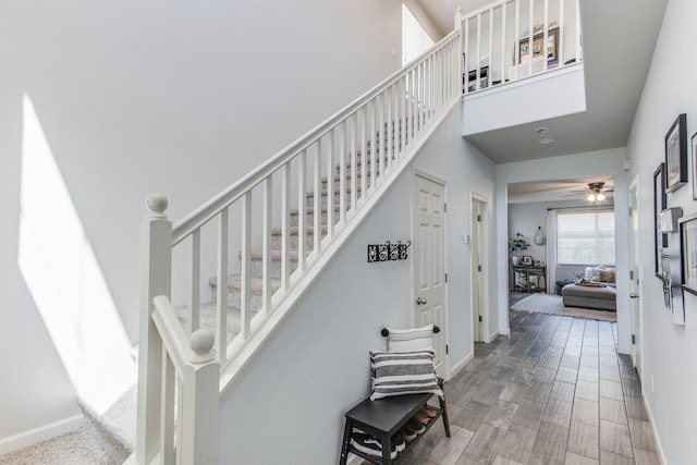 3877 Griffith Ave, Clovis, CA 93619 - stairway featuring baseboards, a high ceiling, wood finished floors, and a ceiling fan