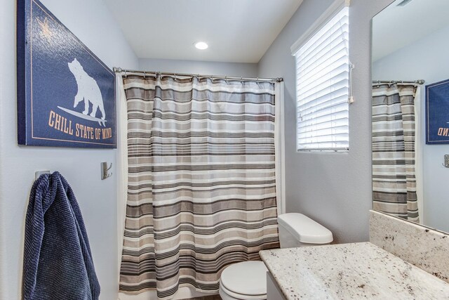 3877 Griffith Ave, Clovis, CA 93619 - full bathroom with toilet, plenty of natural light, vanity, and a shower with curtain