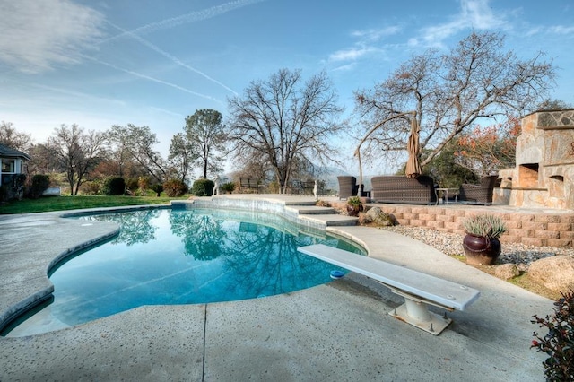 30925 Pennyroyal Ln, Prather, CA 93651 - swimming pool featuring an outdoor stone fireplace, a patio area, and a diving board