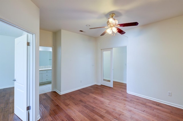 30925 Pennyroyal Ln, Prather, CA 93651 - unfurnished bedroom with wood finished floors, baseboards, and ensuite bath