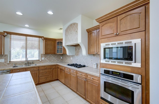 30925 Pennyroyal Ln, Prather, CA 93651 - kitchen featuring appliances with stainless steel finishes, a sink, backsplash, tile countertops, and recessed lighting