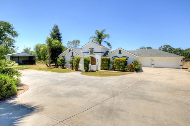 30925 Pennyroyal Ln, Prather, CA 93651 - view of front of property featuring concrete driveway, an attached garage, and stucco siding