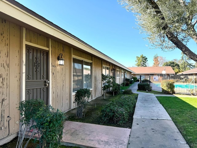 view of exterior entry featuring a community pool