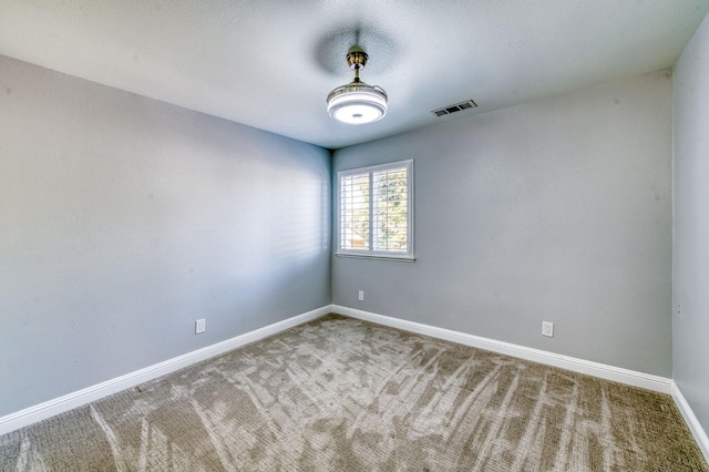 spare room with carpet and baseboards