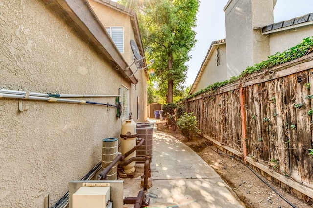 view of home's exterior featuring stucco siding, a fenced backyard, and a patio area