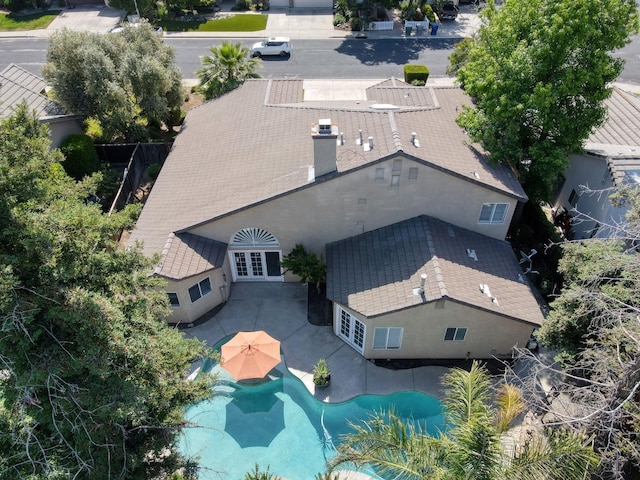 aerial view of property and surrounding area featuring a pool area
