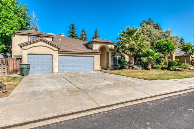 mediterranean / spanish-style house featuring a garage, stucco siding, concrete driveway, a tiled roof, and a chimney