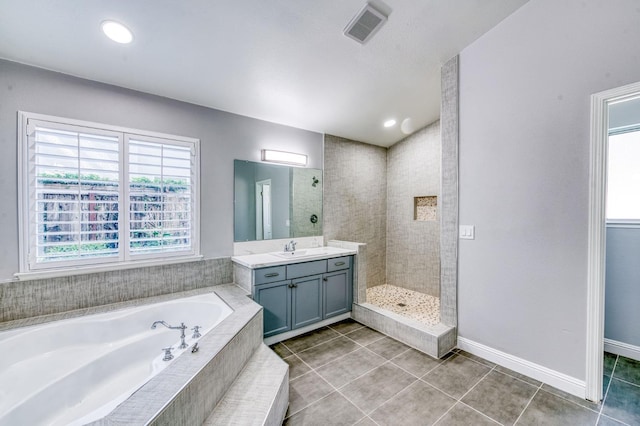 full bath featuring vanity, a garden tub, tile patterned floors, walk in shower, and baseboards