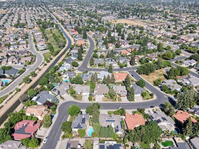 aerial view of property and surrounding area with nearby suburban area