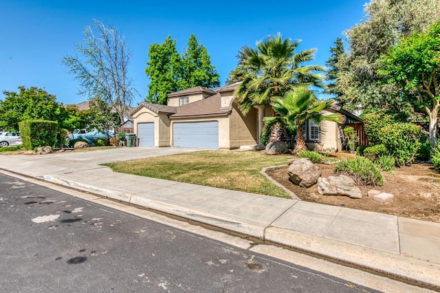 view of front of house with an attached garage, driveway, stucco siding, and a front yard