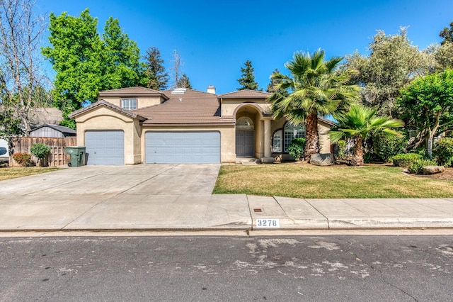 view of front of home featuring a garage, stucco siding, a tiled roof, concrete driveway, and a chimney