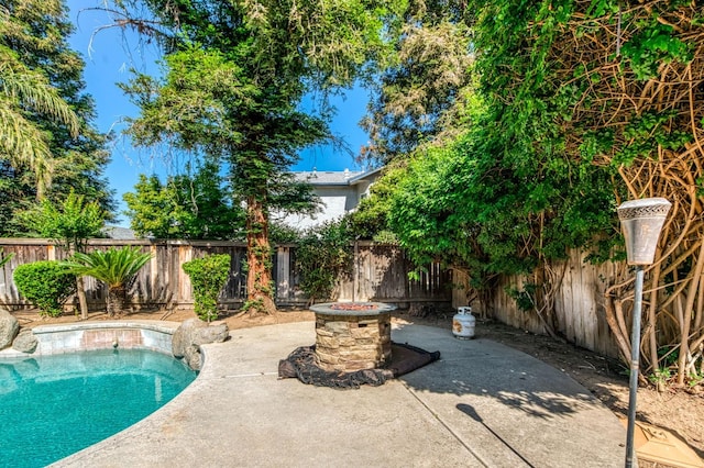 view of swimming pool featuring a fenced backyard and a patio area