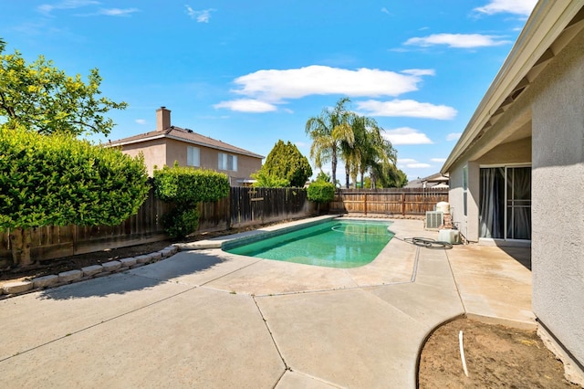 view of pool with a patio, a fenced backyard, and central air condition unit