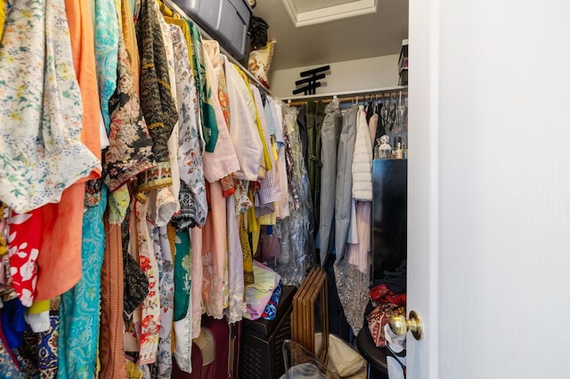 spacious closet featuring attic access