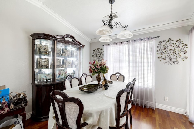 dining space with ornamental molding, wood finished floors, and baseboards
