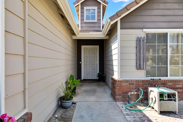 property entrance with brick siding