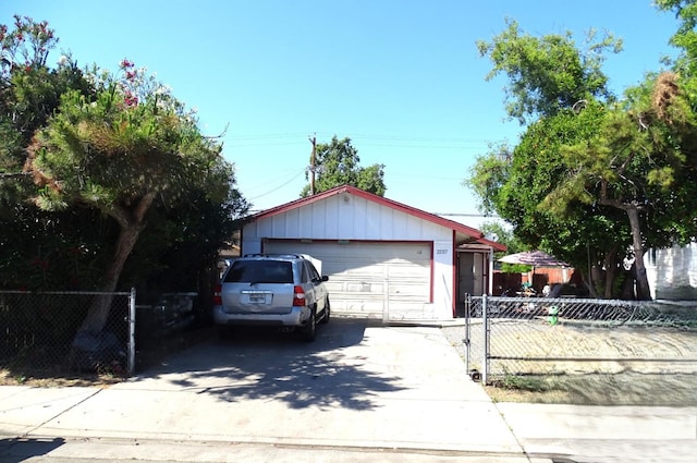 ranch-style house with fence, an outbuilding, and a detached garage