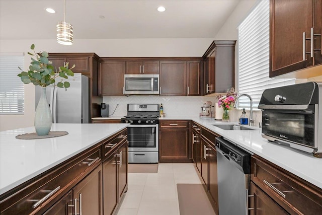 841 Corazon Ave, Clovis, CA 93619 - kitchen featuring stainless steel appliances, light countertops, decorative backsplash, dark brown cabinetry, and recessed lighting