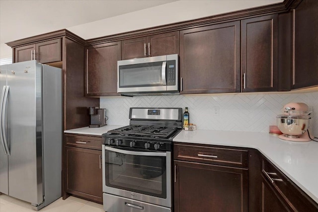 841 Corazon Ave, Clovis, CA 93619 - kitchen featuring stainless steel appliances, dark brown cabinets, light countertops, and backsplash